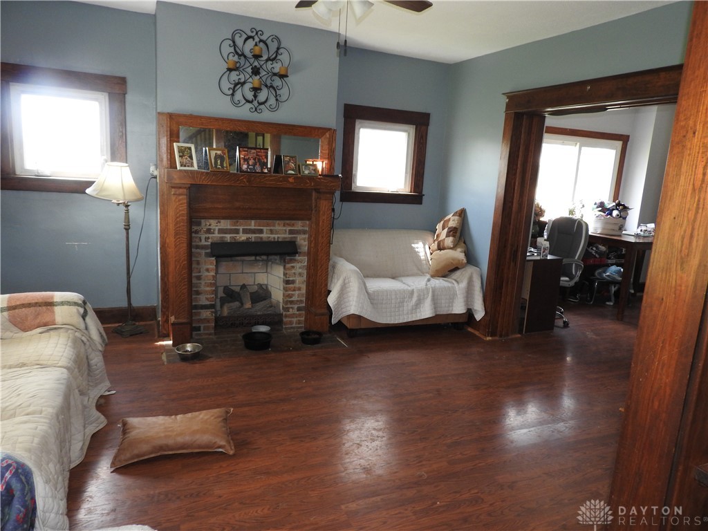 2105 East Loy Road Piqua, OH 45356 - Photo 16 of 26 This inviting living space features a charming fireplace and warm wood flooring.