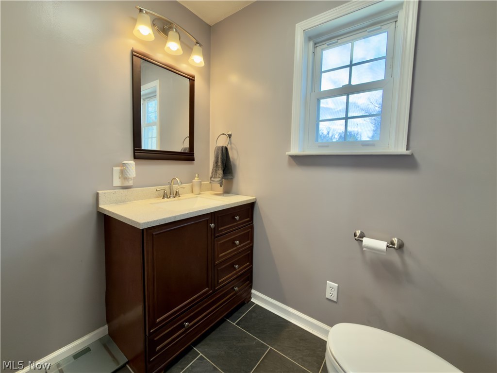 17377 Murphy Road Amesville, OH 45711 - Photo 16 of 43 Half bath with vanity and dark tile patterned flooring