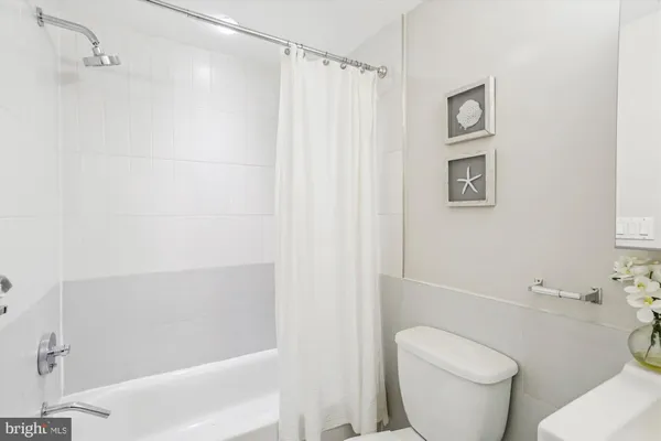 a view of a room with wooden floor and a window