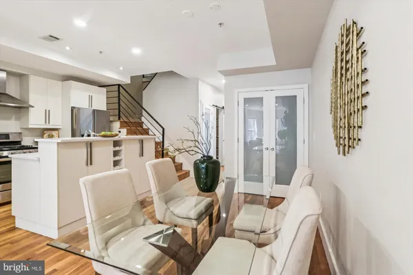 a kitchen with stainless steel appliances a refrigerator sink and stove