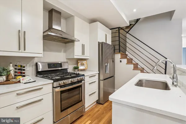 a kitchen that has a sink and a stove in it