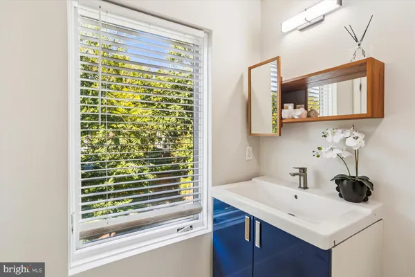 a bathroom with a toilet a sink a mirror and vanity