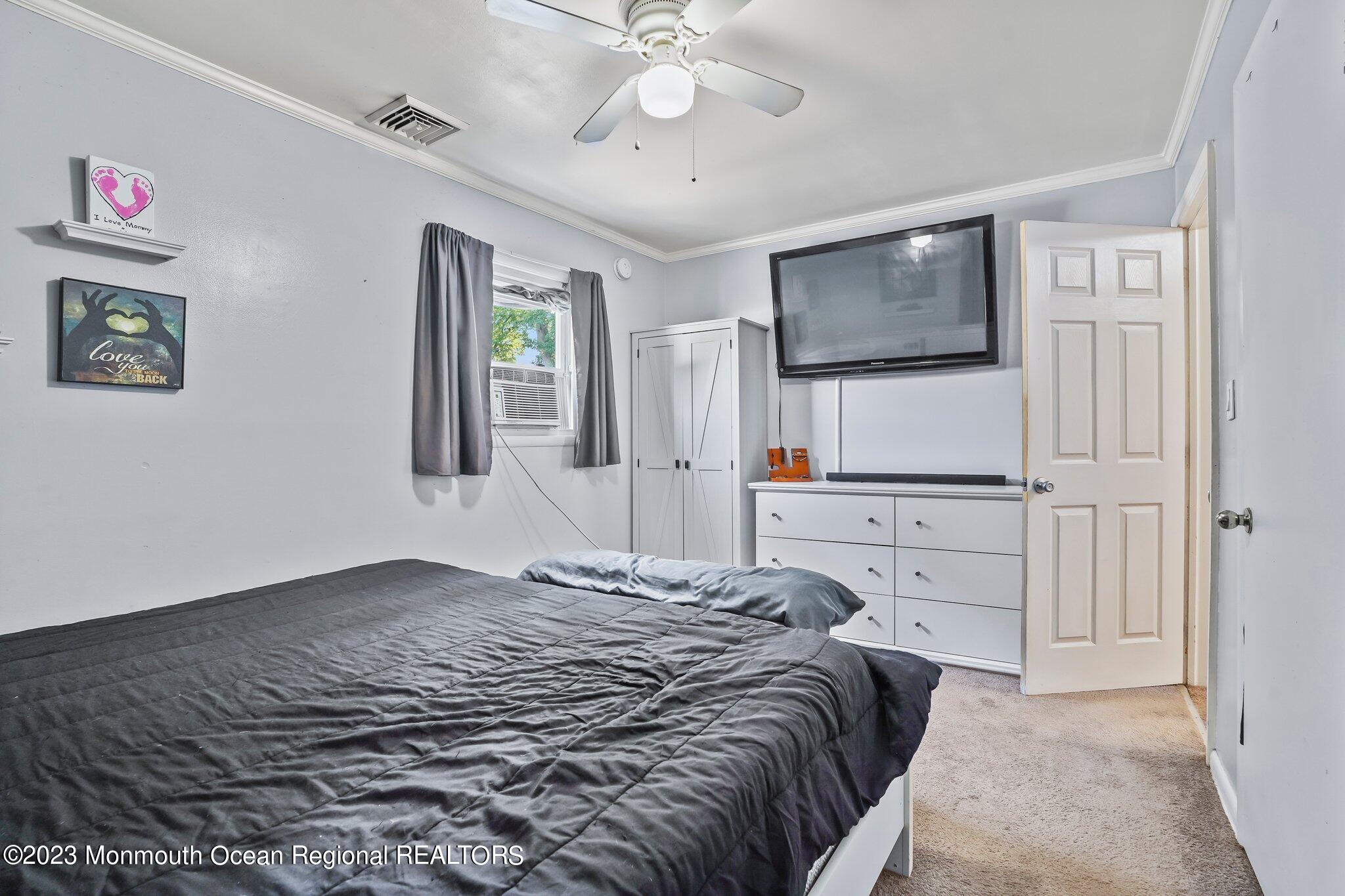 819 Shore Concourse Keyport, NJ 07735 - Photo 13 of 26 a bedroom with a bed and a flat screen tv