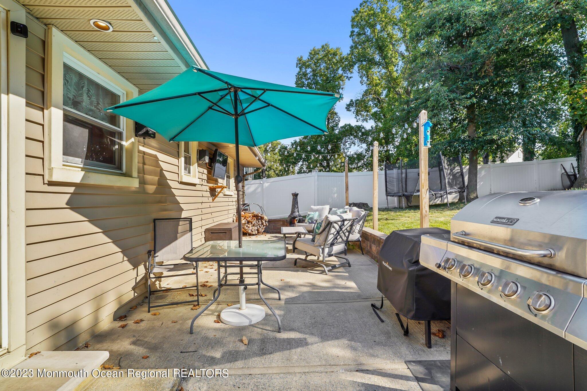 819 Shore Concourse Keyport, NJ 07735 - Photo 18 of 26 a view of a patio with chairs under an umbrella
