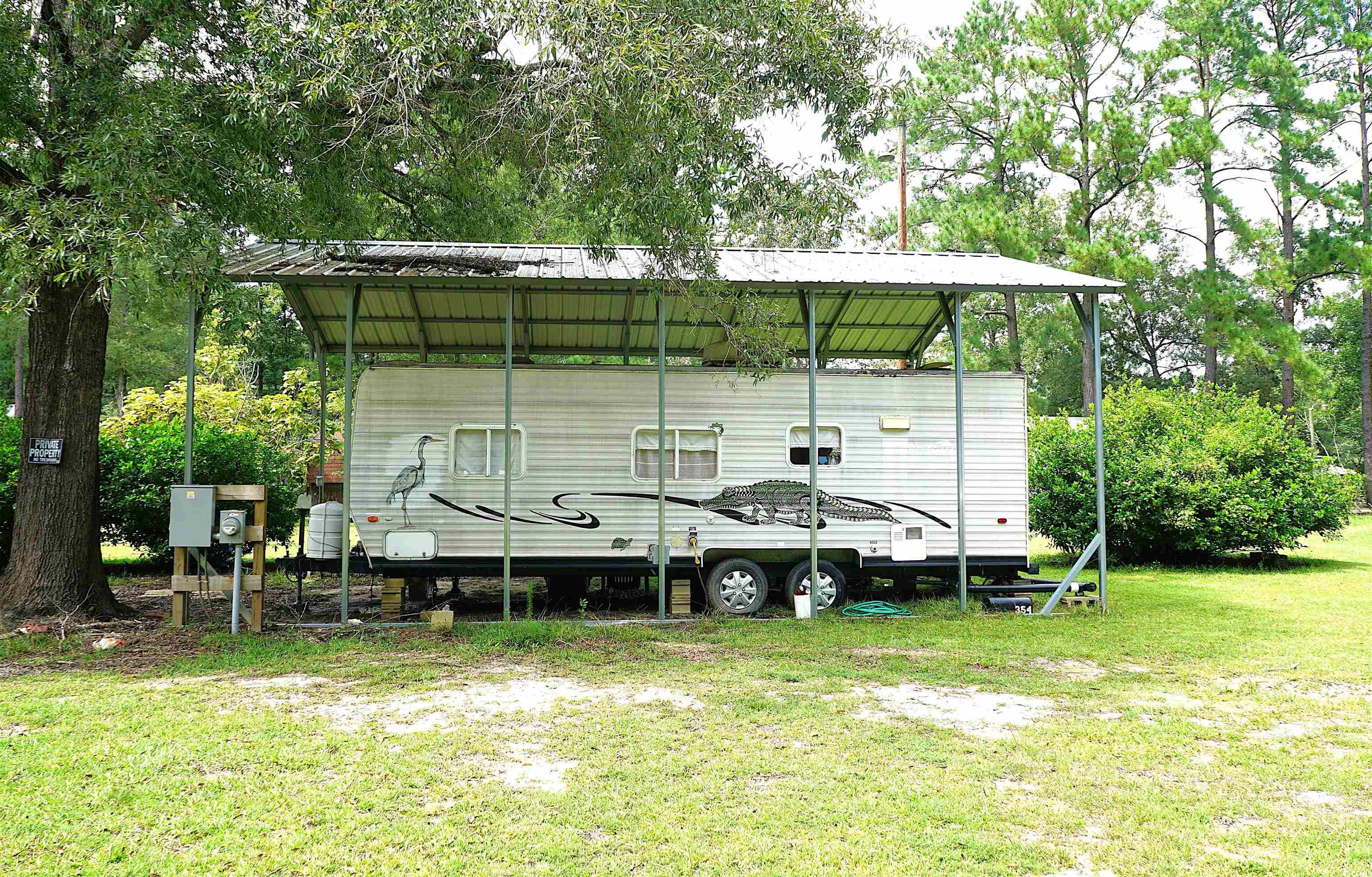 View of grassy yard featuring view of scattered trees