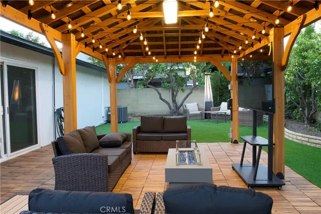 a view of a patio with couches chairs and a yard