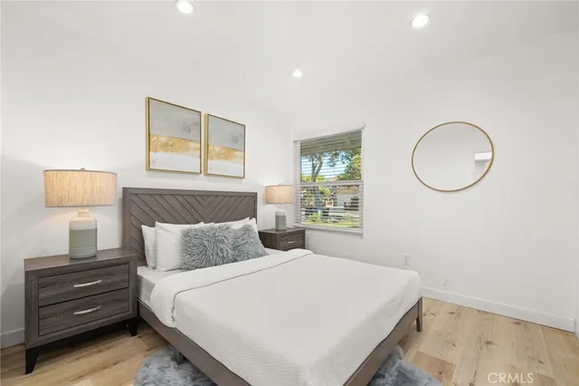 a bedroom with a bed and wooden floor