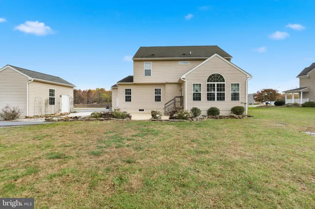 a view of a white house with a yard