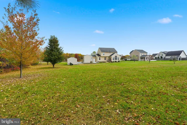 a view of a green field with sitting area