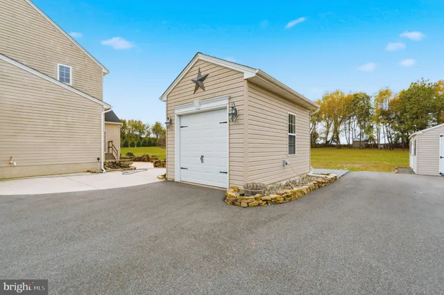 a view of a house with a yard and a garage