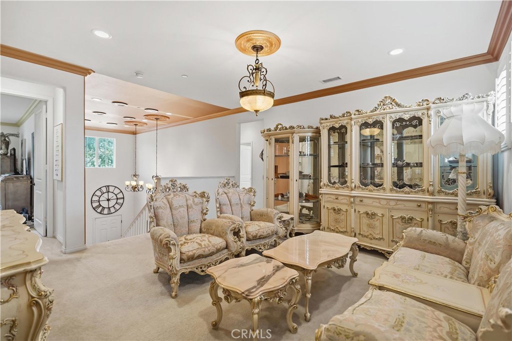 3380 Pine Ridge Loop Ontario, CA 91761 - Photo 18 of 37 a living room with furniture and a chandelier