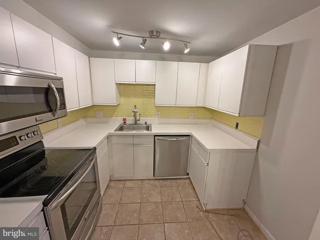 a kitchen with a sink appliances and cabinets