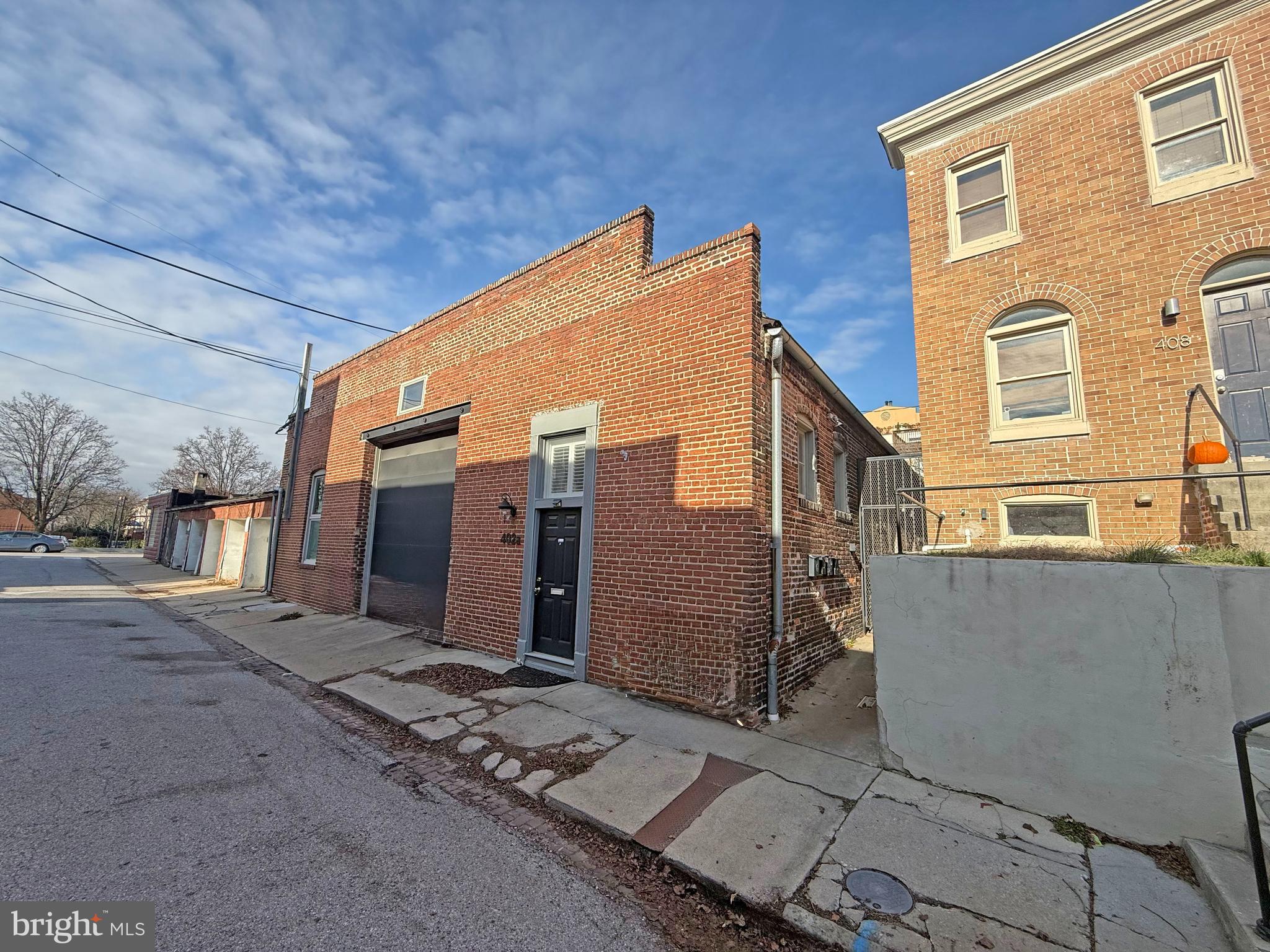 402 Grindall Street, Unit A Baltimore, MD 21230 - Photo 4 of 18 a view of a blue house with large windows
