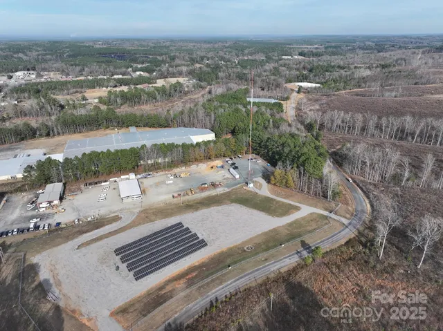 an aerial view of house with yard and mountain view in back