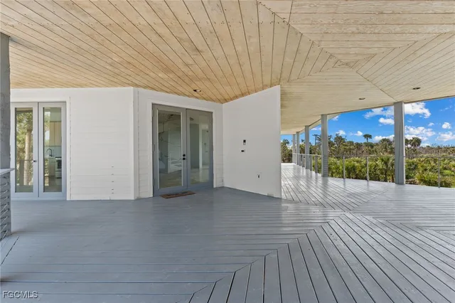 a large white kitchen with a large window