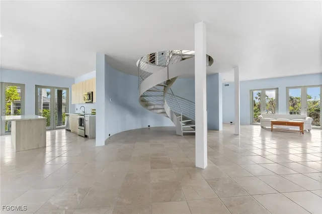 a large white kitchen with cabinets