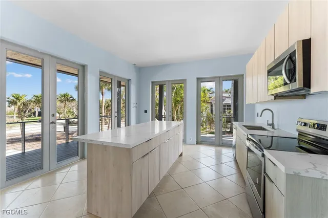 a living room with furniture and floor to ceiling windows