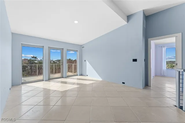 an empty room with windows and yard