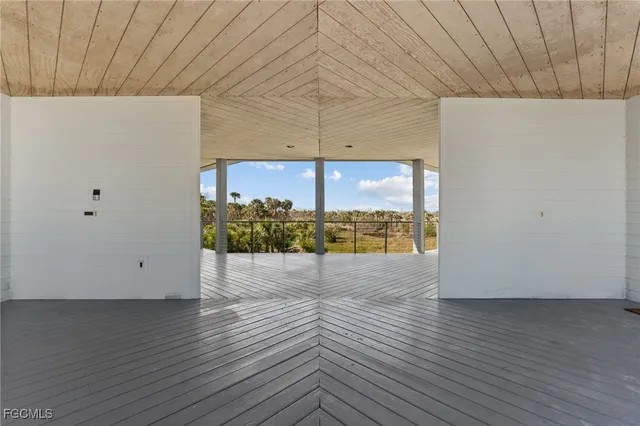 a view of a balcony with wooden floor