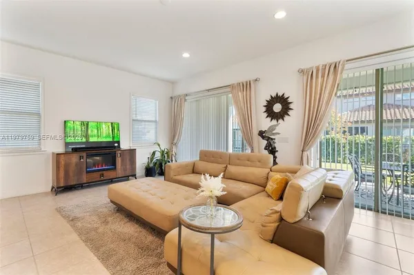 a living room with furniture and a large window