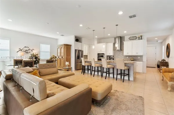 a living room kitchen with furniture and a dining table