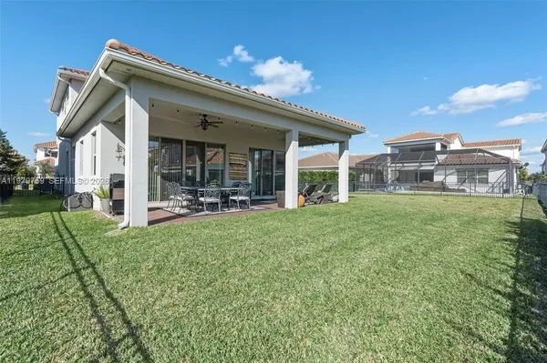 a view of a house with backyard porch and sitting area
