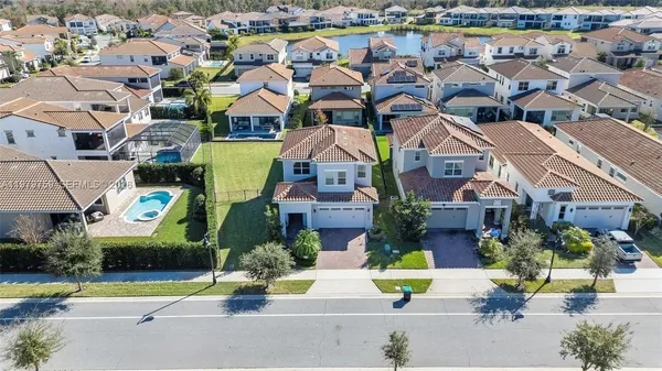 an aerial view of multiple houses with a street