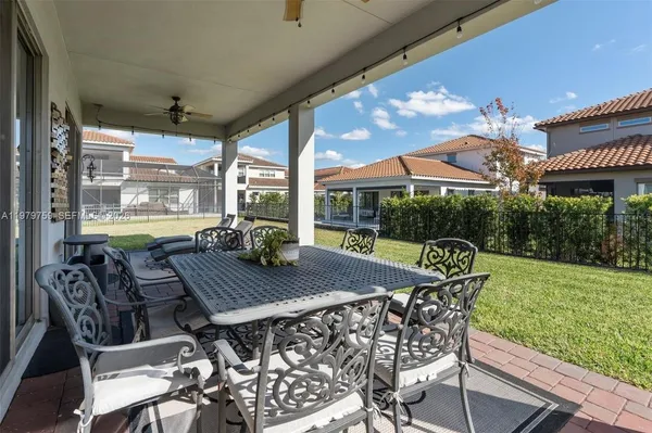 a view of a patio with a table chairs and a backyard