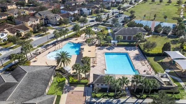 an aerial view of residential houses with outdoor space