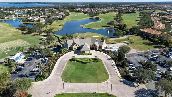 an aerial view of a house with outdoor space and lake view