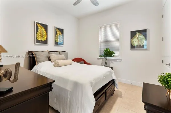 a bedroom with a bed and paintings on the wall