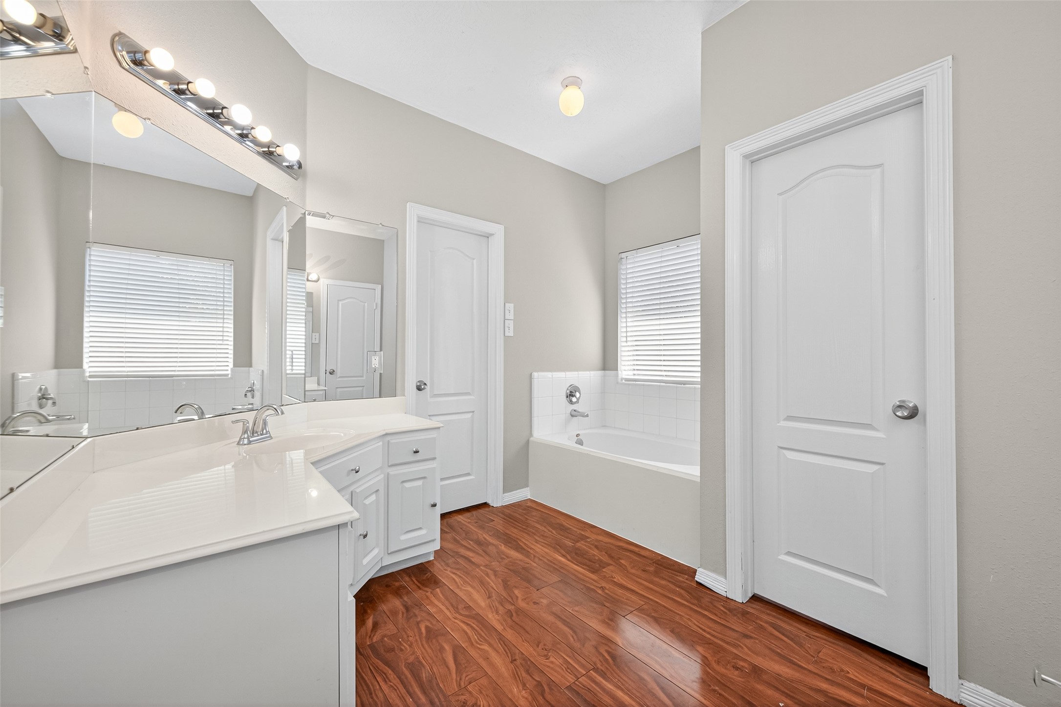 22215 Jay Drive Spring, TX 77373 - Photo 19 of 21 a bathroom with a sink a mirror and a bathtub