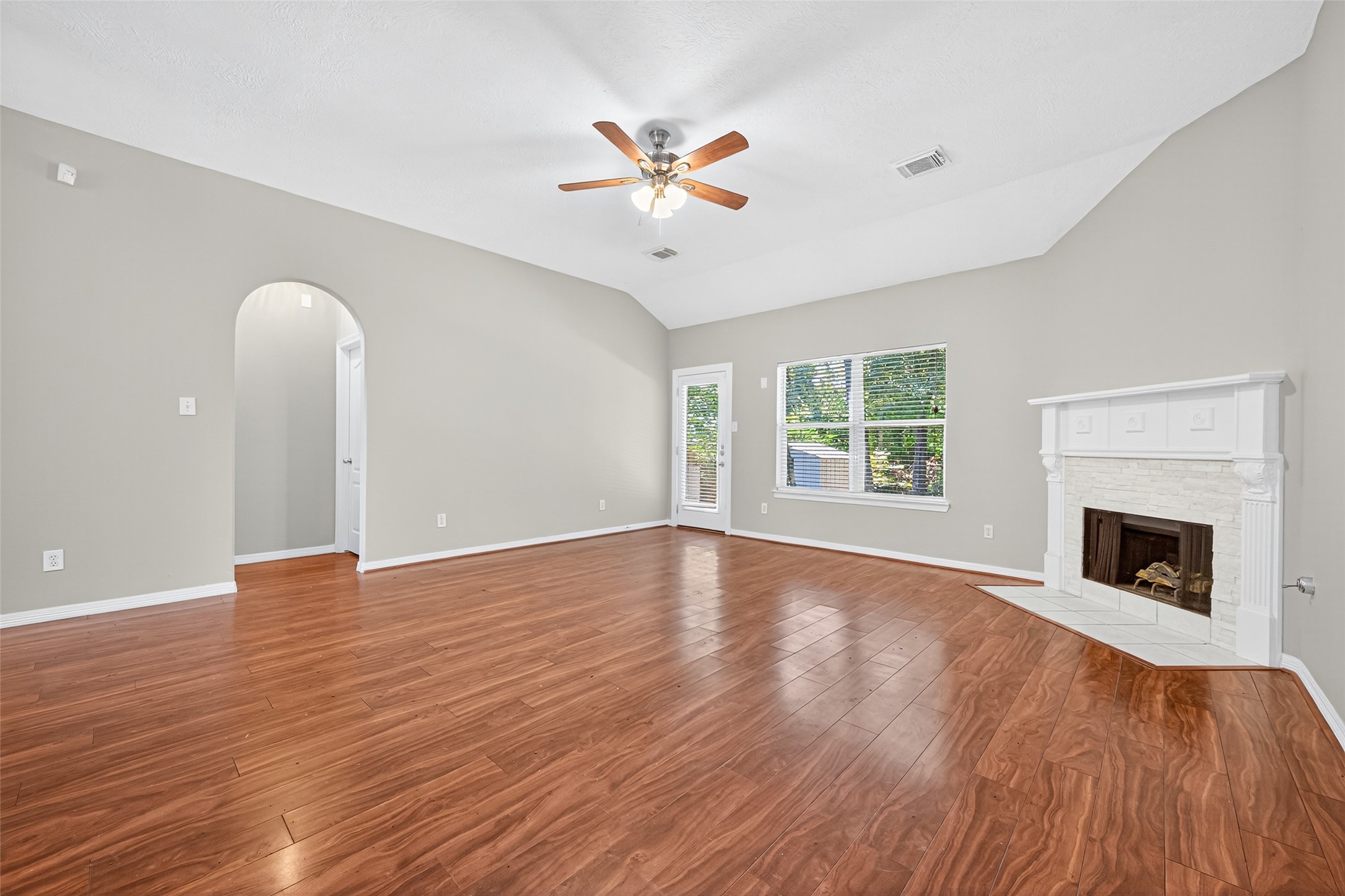 22215 Jay Drive Spring, TX 77373 - Photo 6 of 21 a view of an empty room with wooden floor fireplace and a window