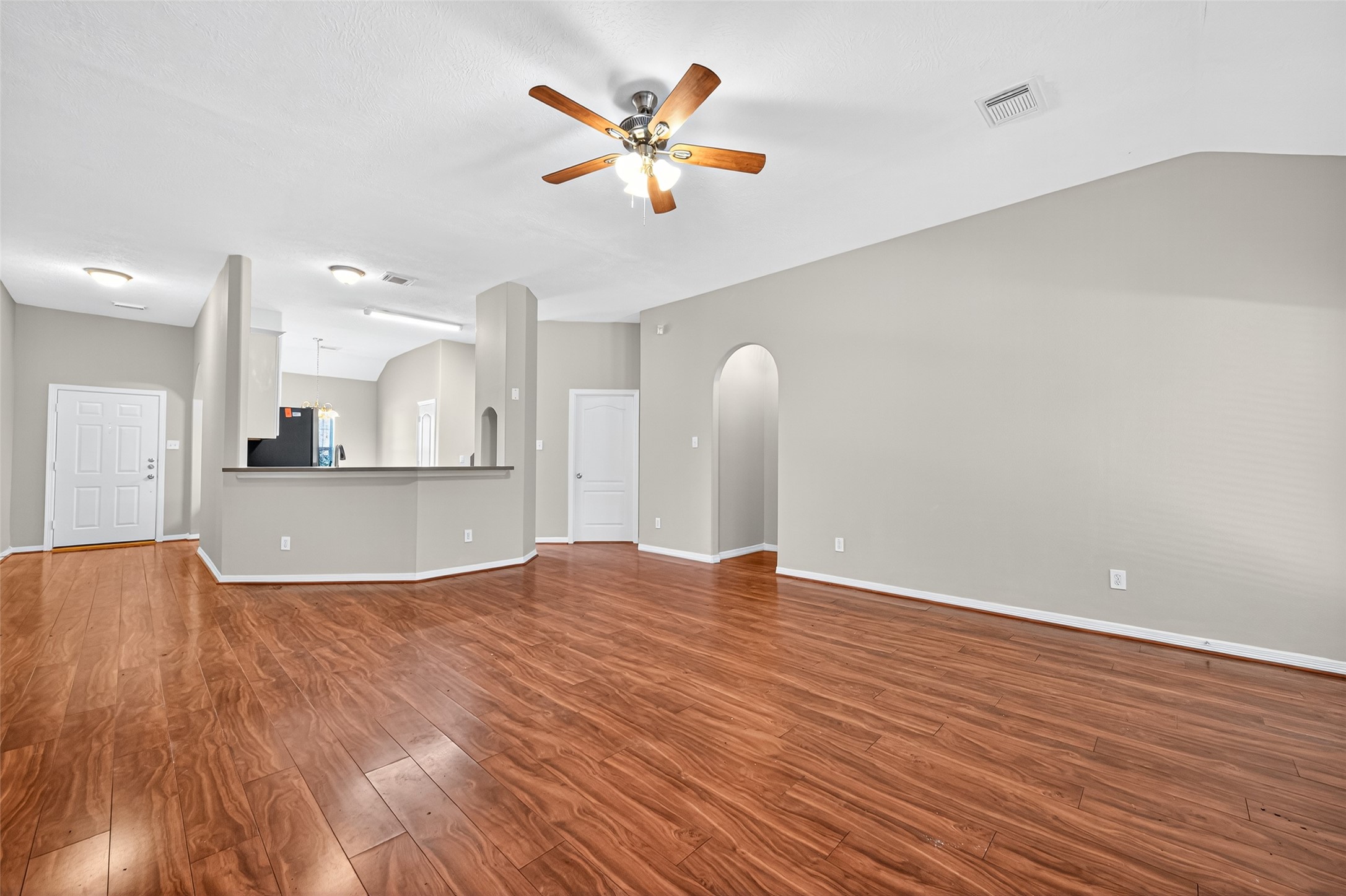 22215 Jay Drive Spring, TX 77373 - Photo 7 of 21 a view of kitchen and empty room with wooden floor