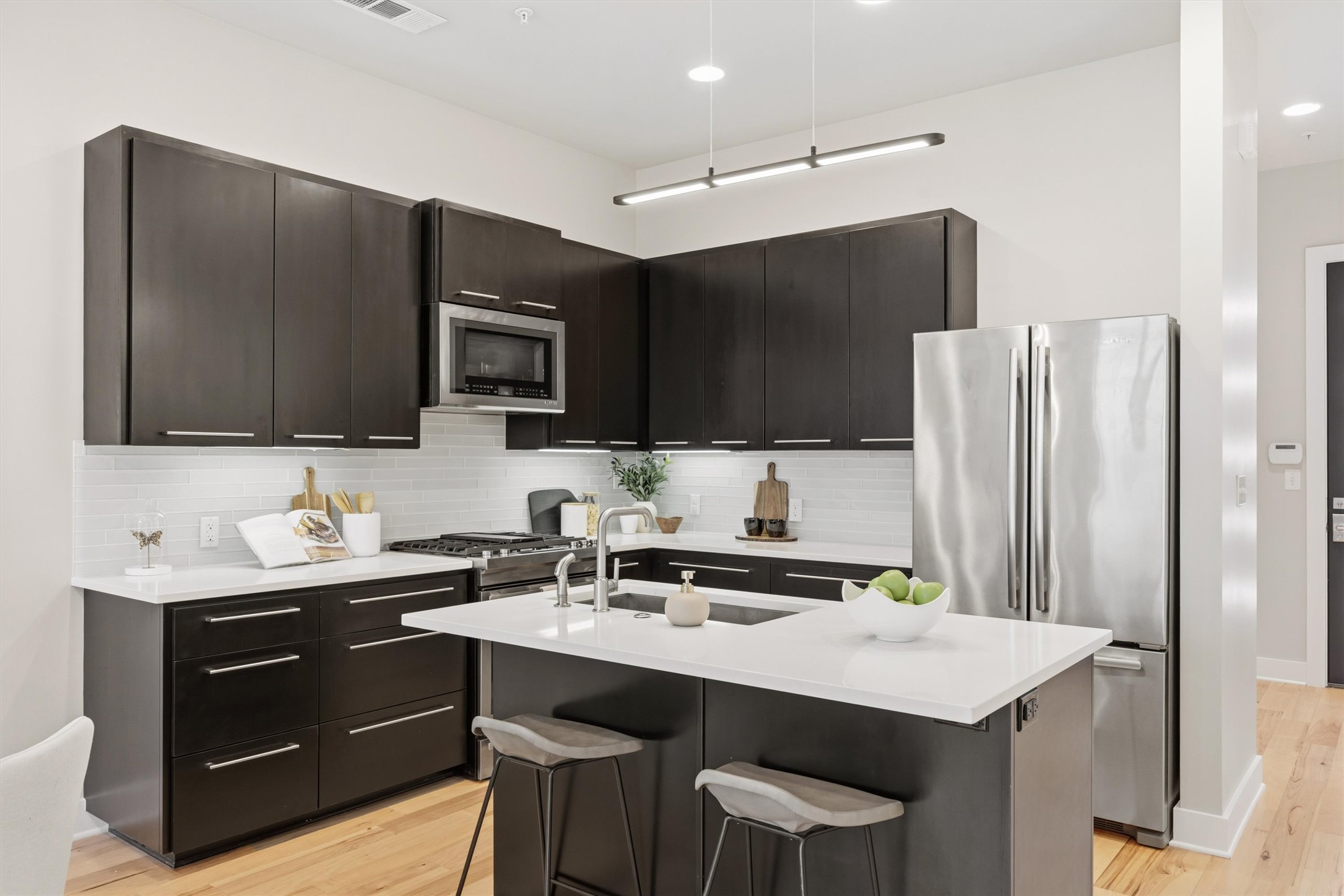 2314 Enfield Road, Unit 203 Austin, TX 78703 - Photo 2 of 37 The oversized island doubles as a breakfast bar — perfect for morning coffee or entertaining guests.
