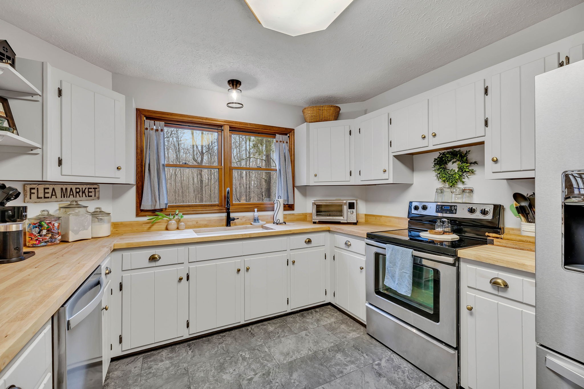 412 Kaiser Road Dickson, TN 37055 - Photo 23 of 53 a kitchen with granite countertop white cabinets and white appliances
