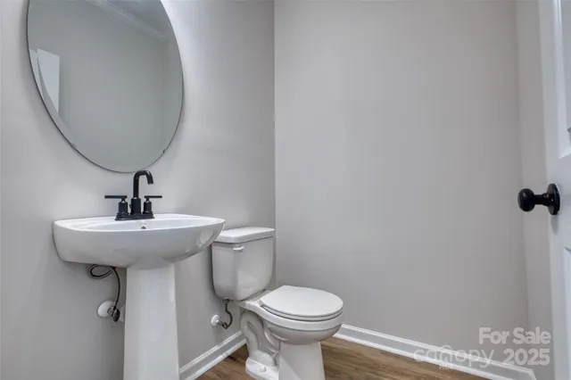 a bathroom with a sink toilet and a mirror