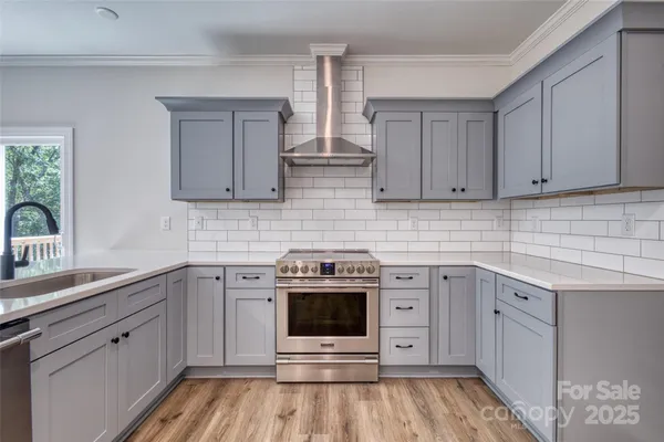 a kitchen with white cabinets stainless steel appliances and sink