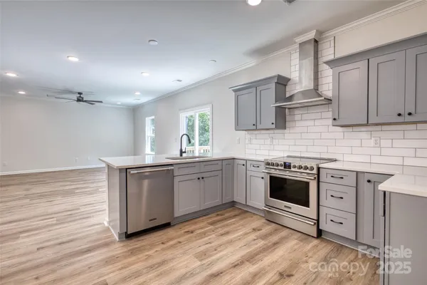 a kitchen with granite countertop cabinets stainless steel appliances and a wooden floor