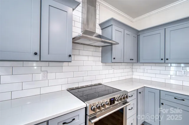 a kitchen with granite countertop a stove and a sink