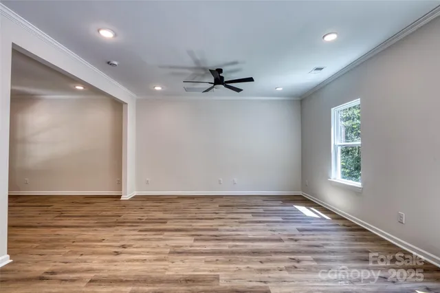 wooden floor in an empty room with a window