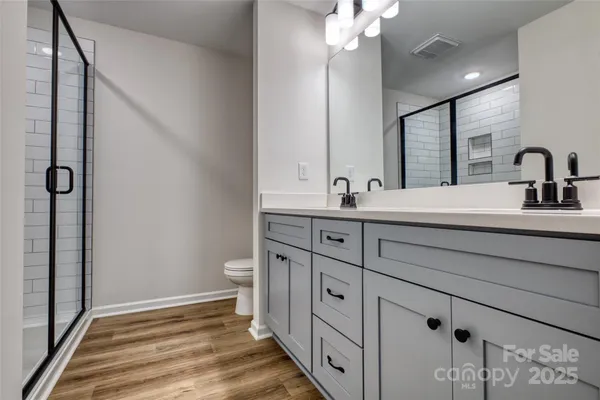 a bathroom with a double vanity sink and mirror