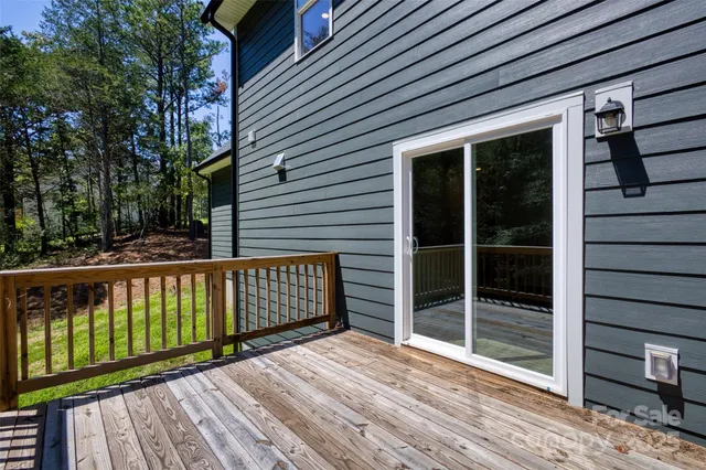 a balcony with wooden floor and fence