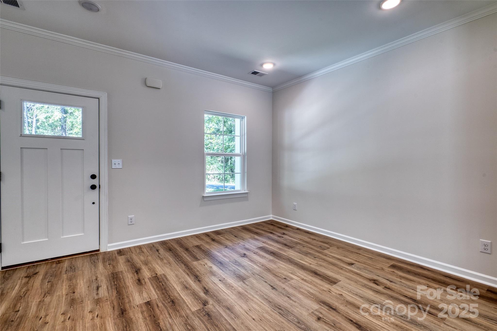 1541 Riverview Circle Fort Lawn, SC 29714 - Photo 7 of 48 a view of an empty room with wooden floor and a window