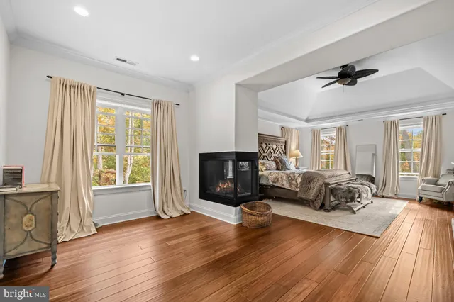 a spacious bedroom with a bed and a chandelier