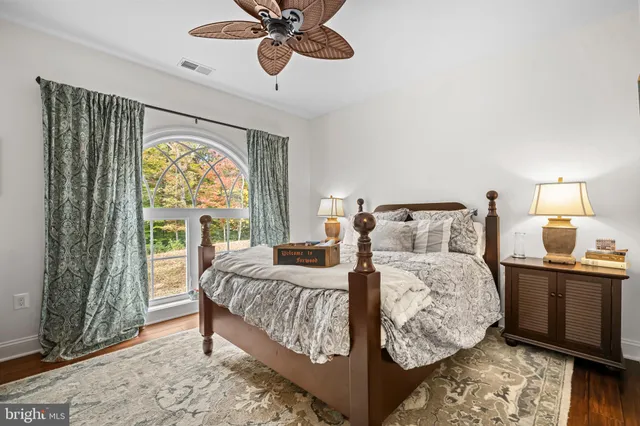 a bedroom with a bed and chair