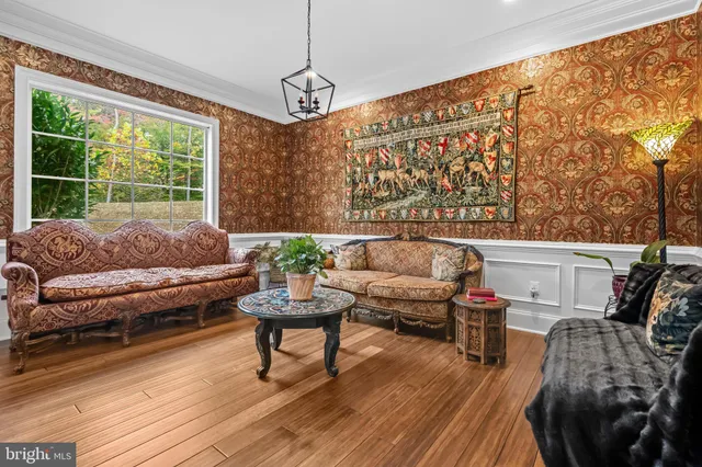 a living room with furniture and a chandelier