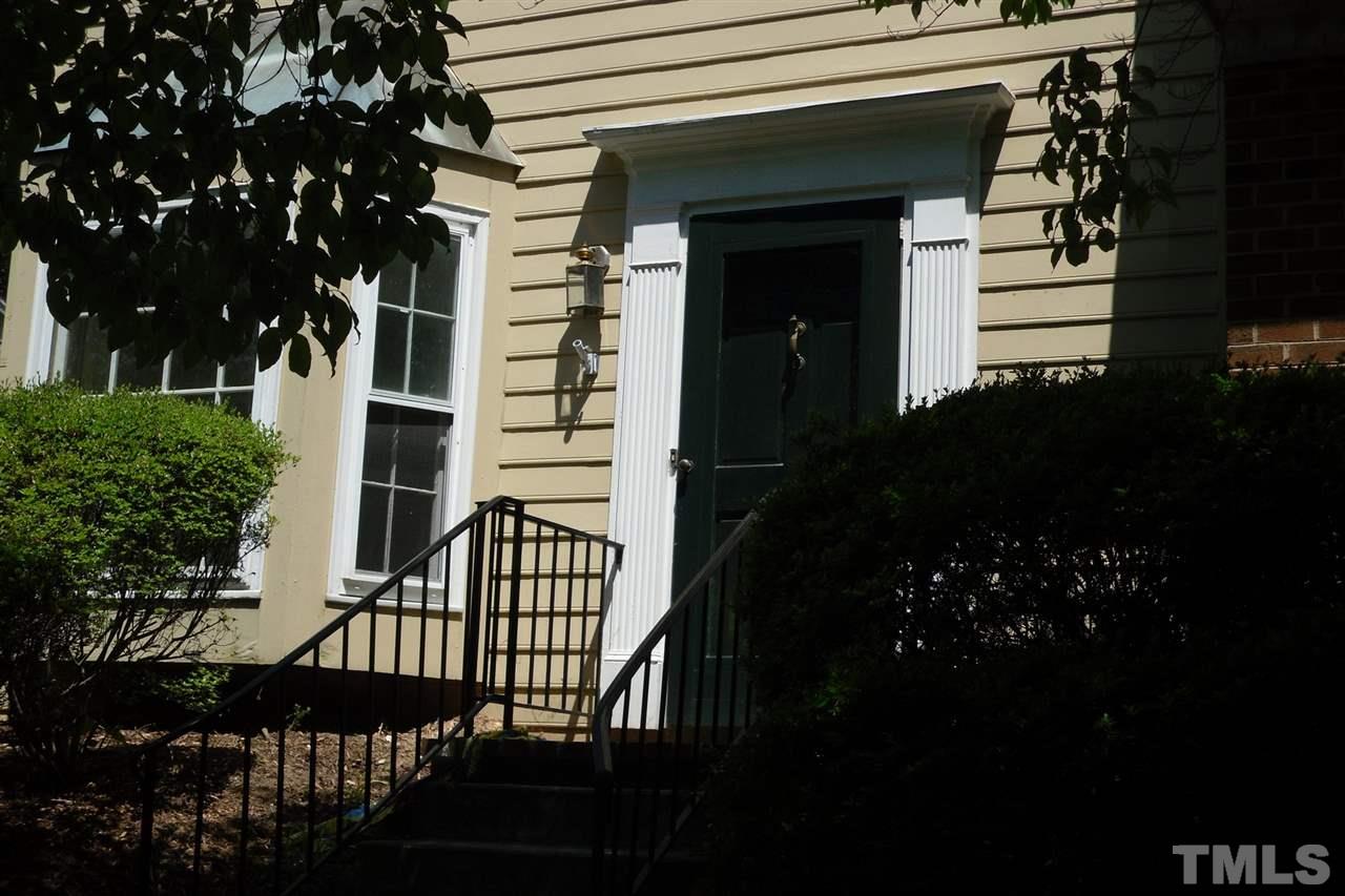 1316 Dylan Heath Court Raleigh, NC 27608 - Photo 2 of 17 a view of entryway with a flower garden and wooden fence