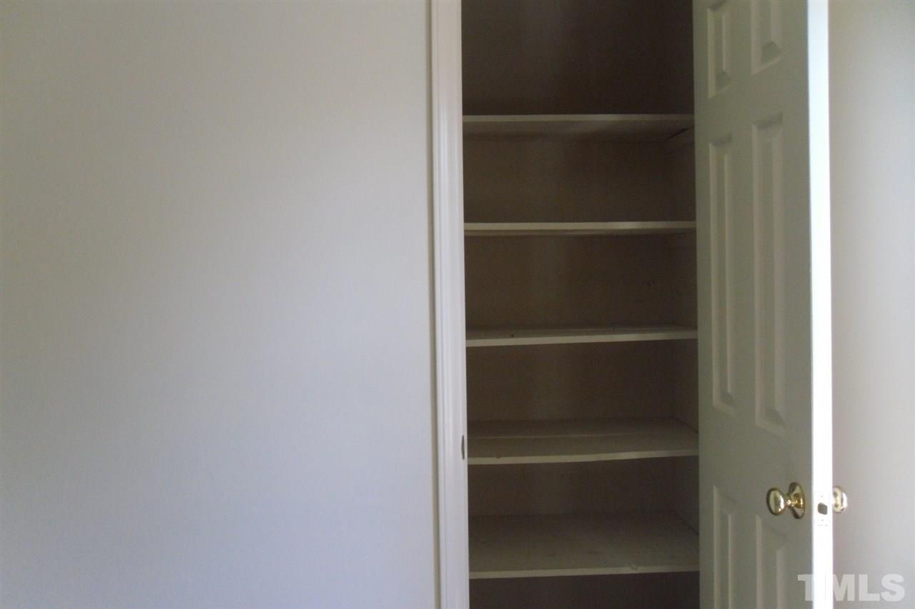1316 Dylan Heath Court Raleigh, NC 27608 - Photo 16 of 17 a view of walk in closet with empty racks