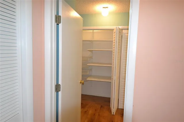 a bathroom with a walk in closet and mirror
